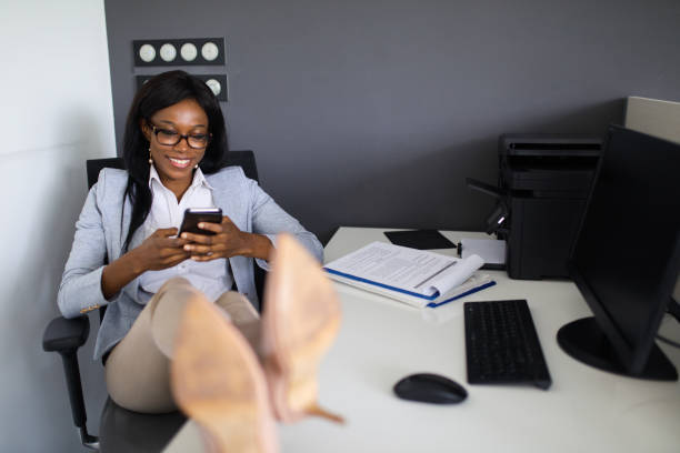 istock Relaxed businesswoman using mobile phone in the office 674041582