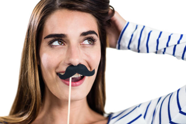 istock Smiling woman holding artificial mustache 674048612