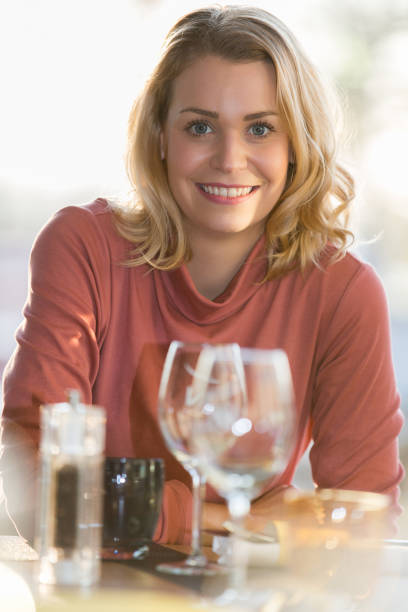 istock beautiful woman sitting in a restaurant 674049226