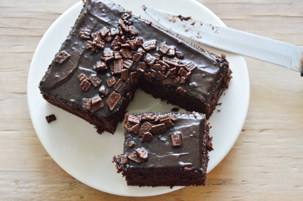 istock chocolate butter cake cut for piece and knife blade 674056300