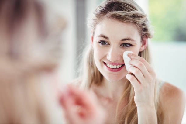 istock Happy young woman applying blush 674076880