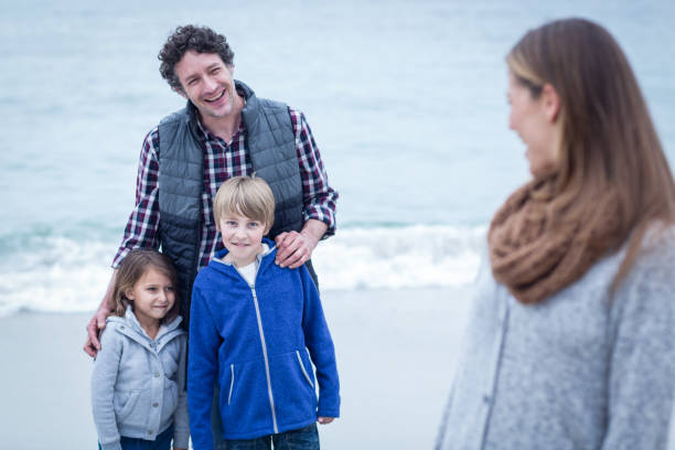 istock Happy father with children looking at mother 674090930