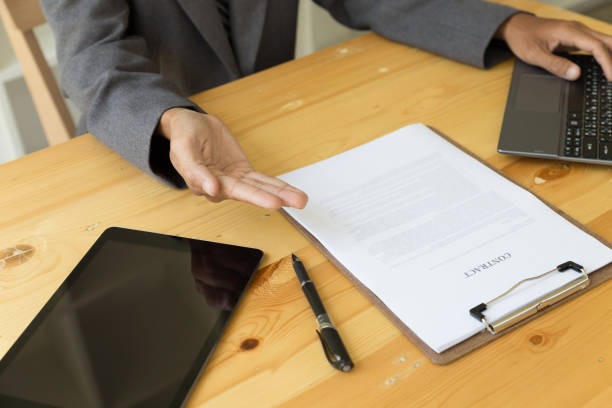 istock businessman with a contract giving a hand - presenting & signing business document 674091702