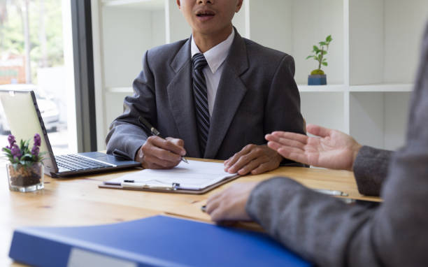 istock applicant's hand holding ballpoint pen writing on empty application form paper. Business person fill in blank document sheet applying job position, mortgage loan, registering registration information 674091748