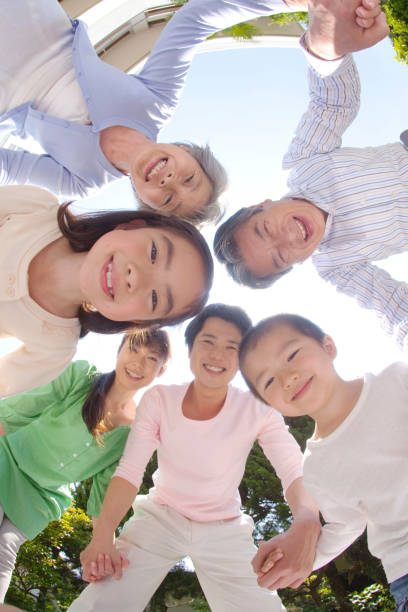 istock Three generations in a circle, laughing family 674092104