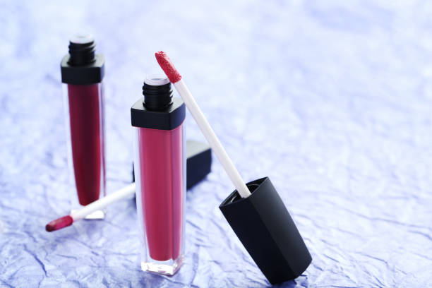 istock Colorful lip gloss on blue paper background 674092194