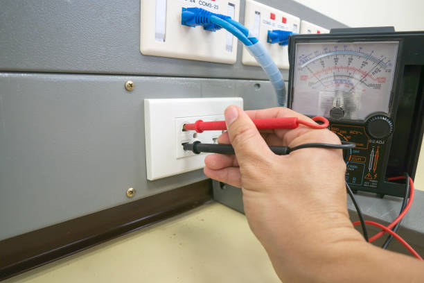 istock Closeup of electrician checking electrical current in a wire white multimiter 674096370