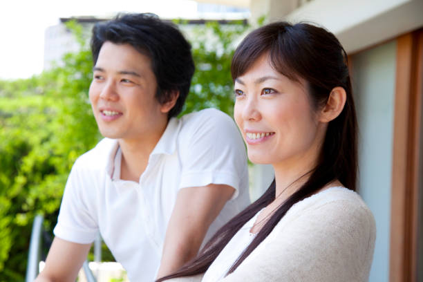 istock A couple look out from the balcony 674097454