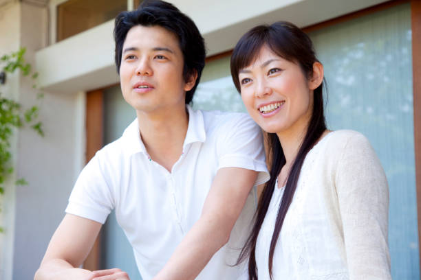 istock A couple look out from the balcony 674097466