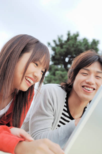 istock College couple into the laptop 674102288
