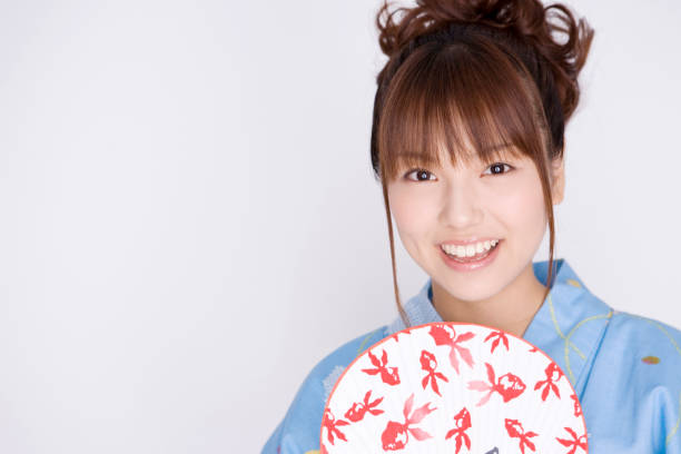 Women have a fan wearing a yukata