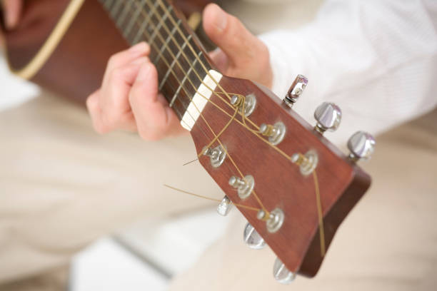 istock Senior man with a guitar in hand 674107732