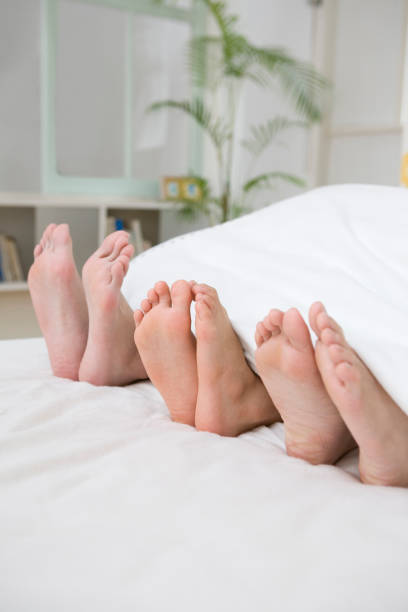 Sole parents and boys Sole parents and boys bed human foot couple two parent family stock pictures, royalty-free photos & images