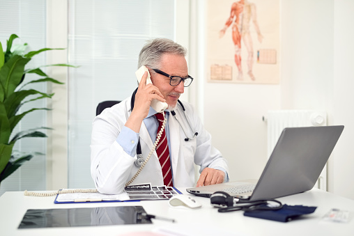 Doctor talking on the phone in his studio