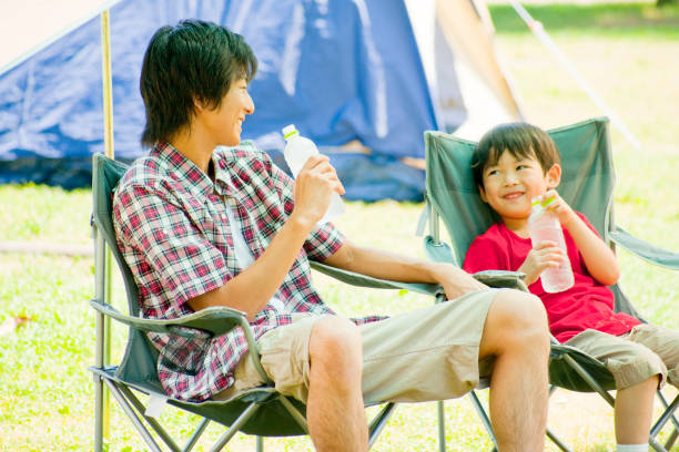 istock His father sitting in a camping Chair, chatting with my son 674108832