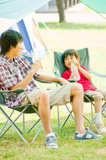 istock His father sitting in a camping Chair, chatting with my son 674108842