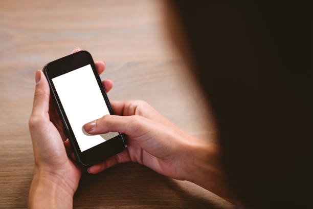istock Rear view of woman using mobile phone 674109092