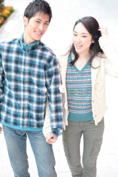 istock Couples hold hands, walk down the street 674125430