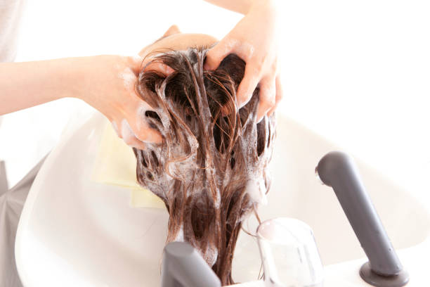 istock Women at a hair salon shampoo 674132908