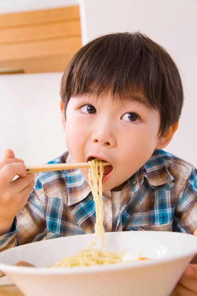 istock Boy eating ramen noodles 674133058