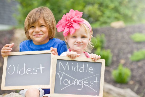istock Children Holding Birth Announcement Signs 674133320