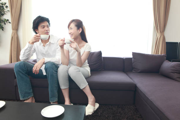 istock Couple on the couch drinking coffee and chatting 674140364