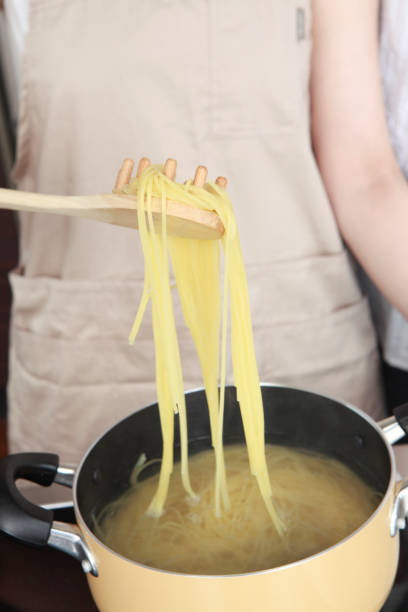 istock Local women boil pasta 674140764
