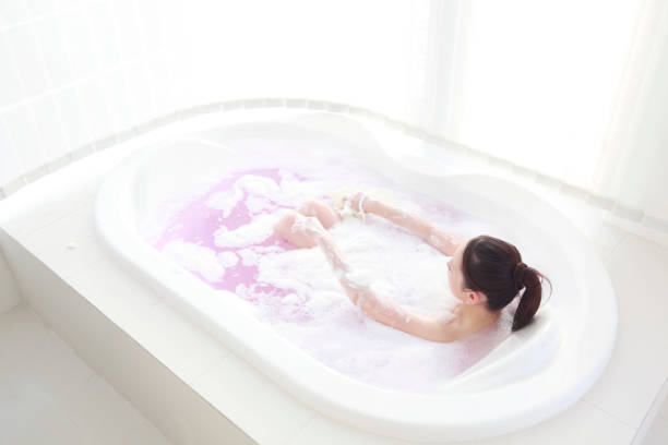 istock Women wash the body in bubble bath 674146690