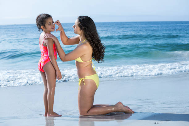 istock Mother applying cream to daughter 674146922