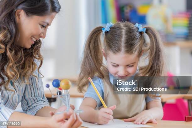 Teacher Assignment Math Teacher Helps Young Student With Math Assignment Stock Photo - Download ...
