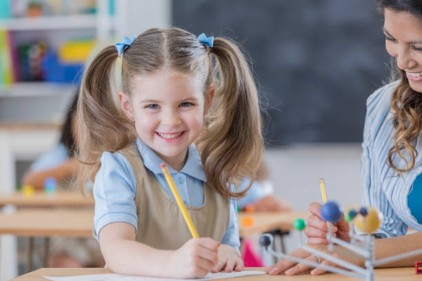 istock Happy Caucasian schoolgirl in science class 674146992
