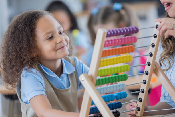 istock Preschool girl uses abacus in class 674147008