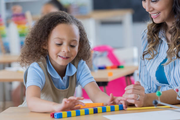 istock Little girl counts counting cubes at school 674147032