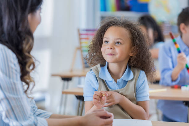 istock Attentive preschool student with teacher in class 674147058