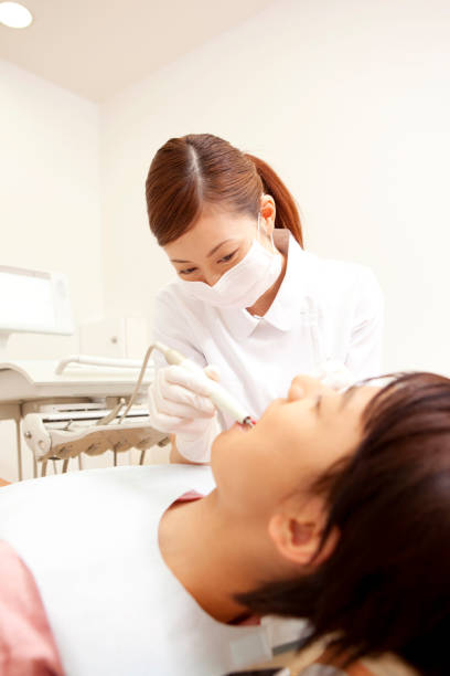 istock Men subjected to dental hygiene and therapy 674147540