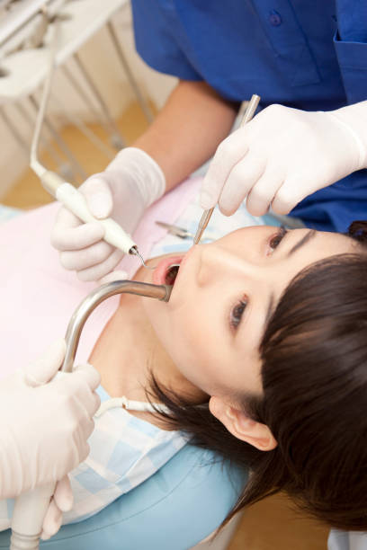istock Female patients undergoing dental treatment 674152684