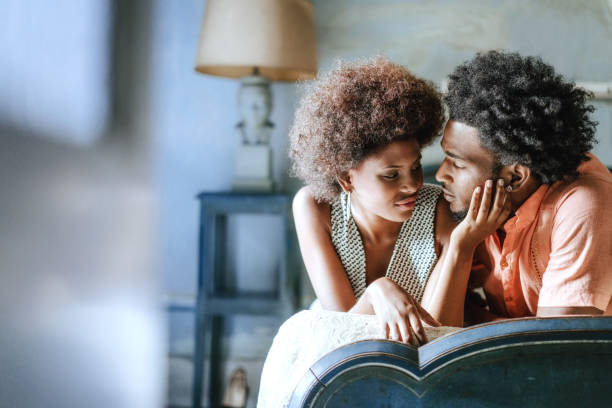 istock Romantic couple looking at each other while relaxing on bed at home 674153630