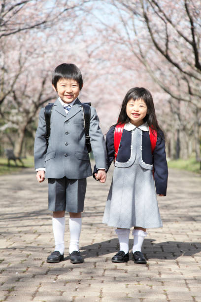istock Cherry elementary school men and women standing under a tree 674153824