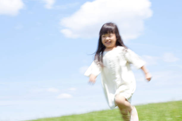 istock Girl running with smiles the Meadow 674154552
