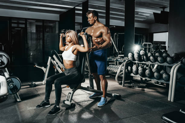 istock Fitness instructor exercising with his client at the gym 674160112