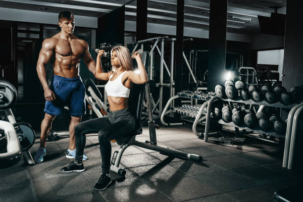 istock Fitness instructor exercising with his client at the gym 674160226