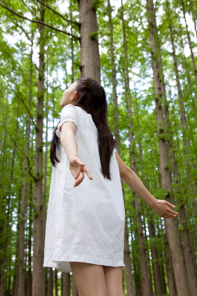 istock Women with both hands in the Woods 674160462