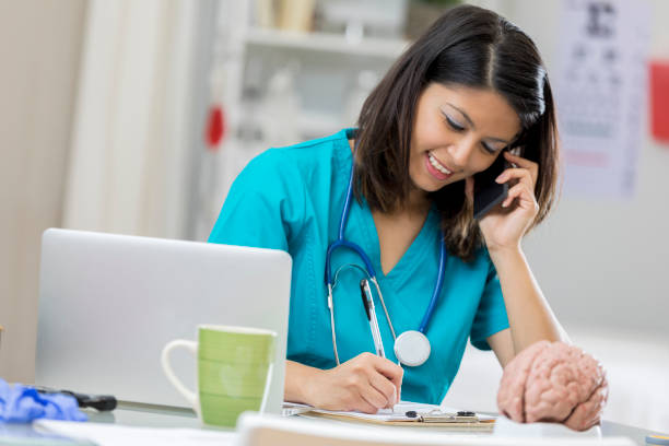 istock Cheerful neurologist uses smart phone 674163524