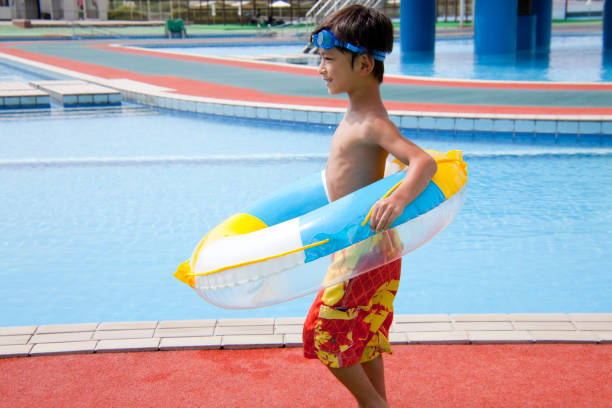 istock Boy wearing a swimsuit with ring 674163916