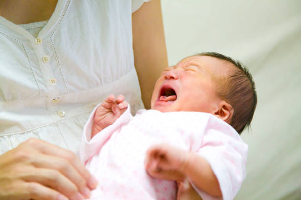 istock Baby in its mother's arms 674164210