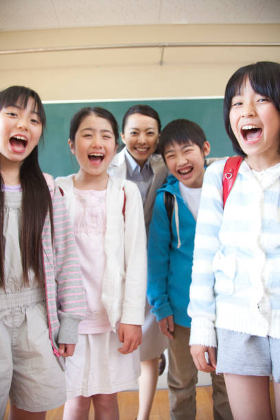 istock Smiley elementary school male and female teachers 674169764