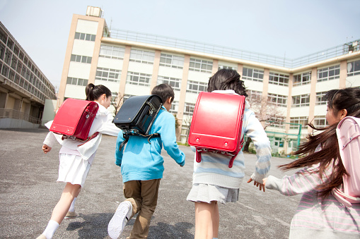 Vista posterior de los estudiantes de la escuela primaria van a la escuela cuatro photo