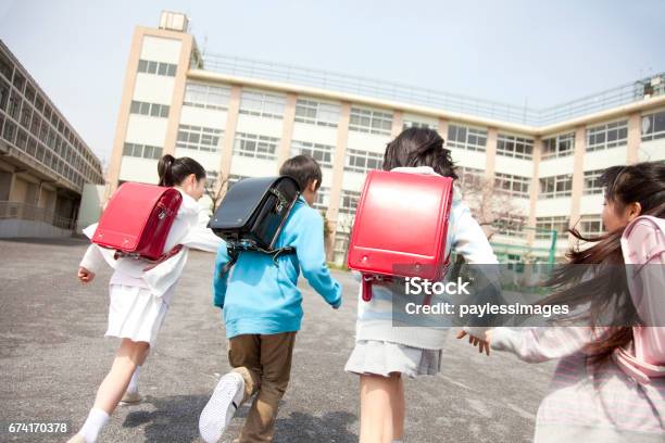 Rear View Of The Elementary School Students Go To School Four Stock Photo - Download Image Now