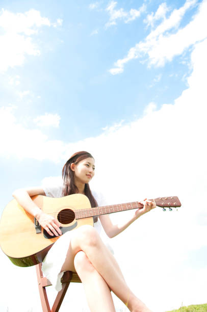 istock Woman playing the guitar 674170630