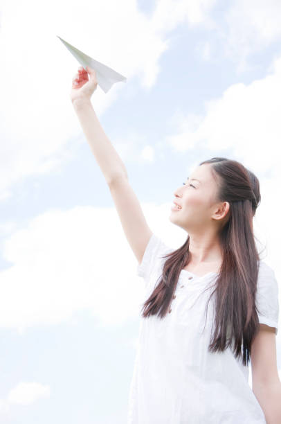 istock Woman holding paper airplane 674170782